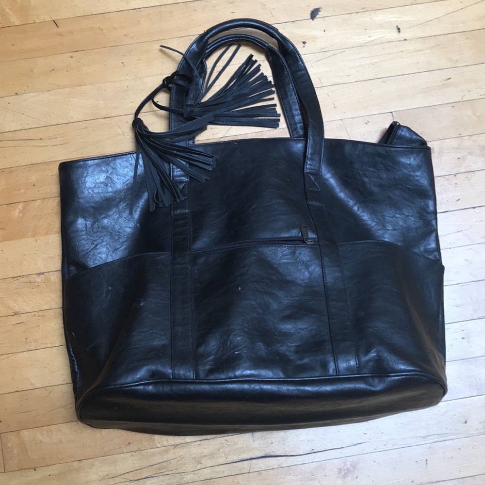 Large black leather shoulder bag with tassels